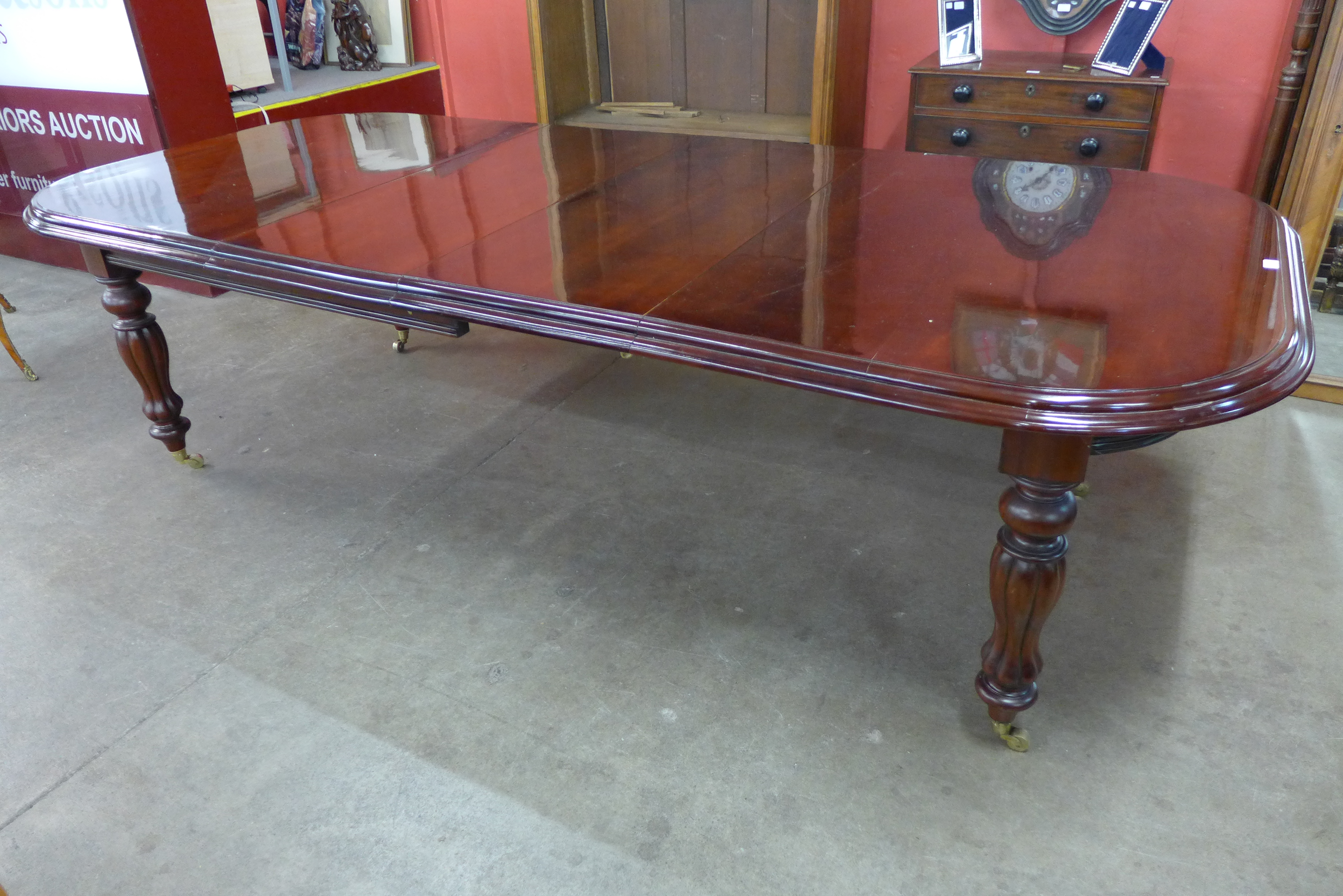 A Victorian style mahogany extending dining table