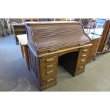 An Edward VII oak tambour roll top desk