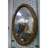 An early 20th Century oval painted framed mirror