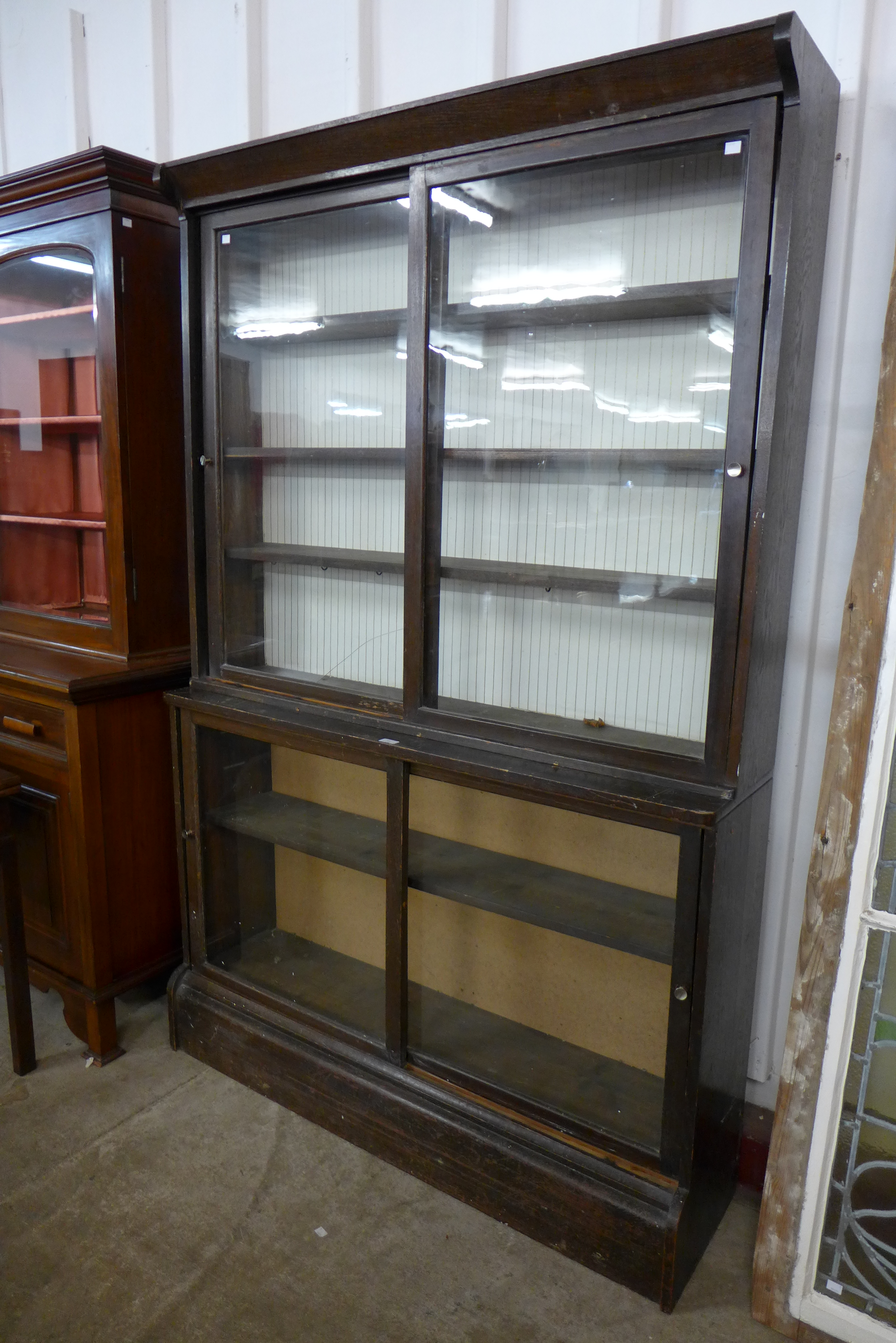 A Victorian oak sliding door bookcase