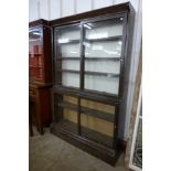 A Victorian oak sliding door bookcase