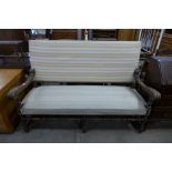 A French carved elm and upholstered settle