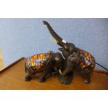 A figural elephant table lamp with Tiffany style shade