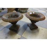 A pair of small Victorian cast iron campana garden urns