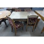 A Victorian mahogany extending dining table and four Edward VII oak and upholstered dining chairs