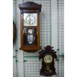 A mahogany wall clock and a beech wall clock