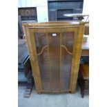 A walnut single door display cabinet