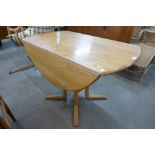 An Ercol Blonde drop leaf table