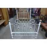 A Victorian painted cast iron and brass double bed