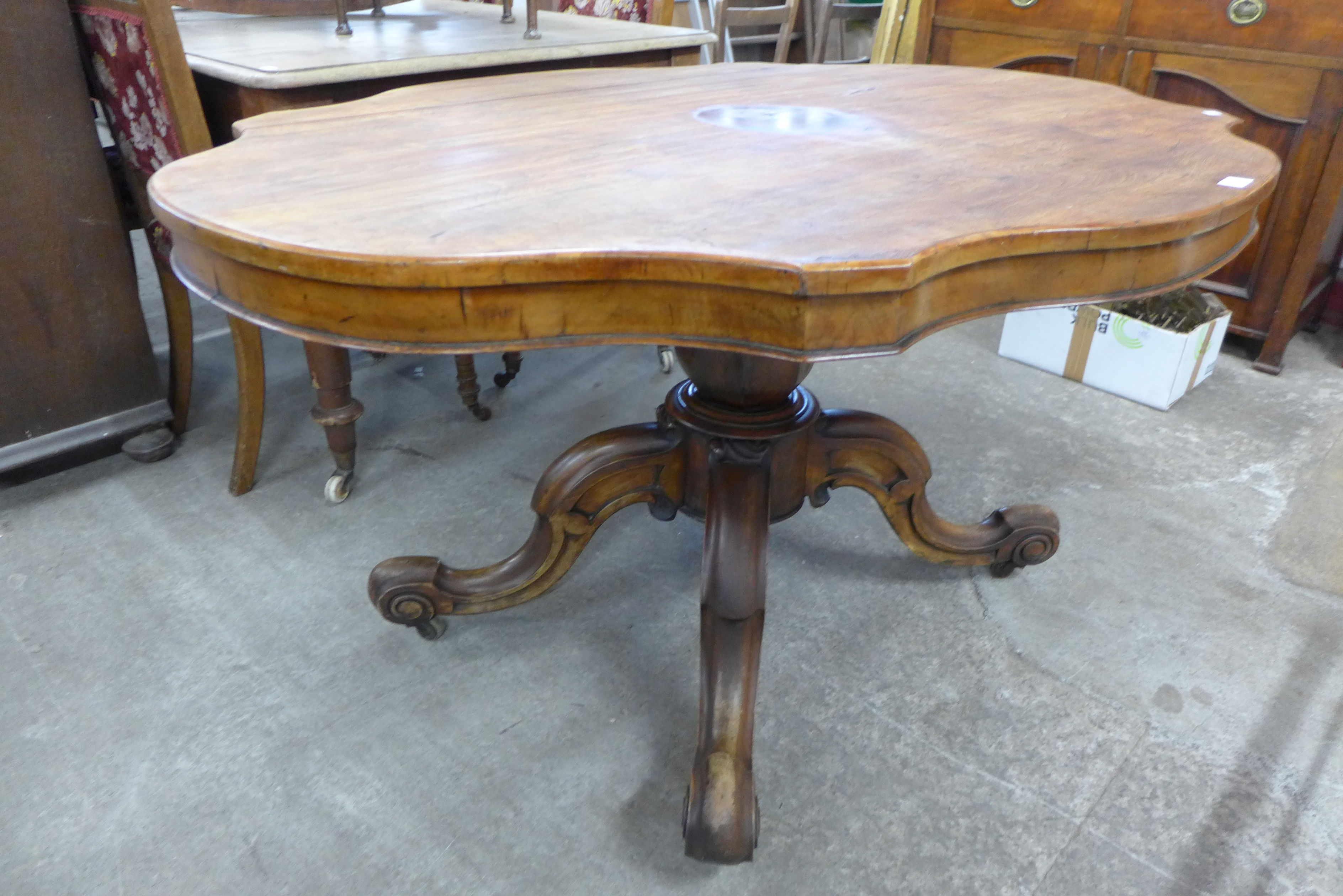 A Victorian walnut serpentine tilt-top breakfast table