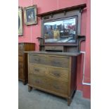 An Arts and Crafts oak dressing chest by Harris Lebus