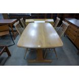 An Ercol Blonde dining table and four chairs