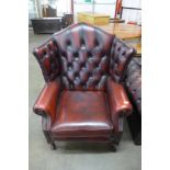 An oxblood leather wingback armchair