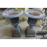 A pair of Victorian cast iron campana garden urns