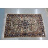 A Persian cream ground rug, 96cm x 150cm