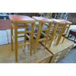 A set of four beech laboratory stools