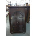 A George III mahogany corner cupboard