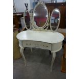 A French style cream and parcel gilt dressing table