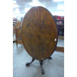 A Victorian walnut oval tilt-top loo table