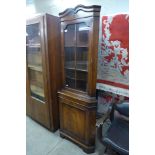 A mahogany freestanding corner cabinet