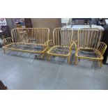 An Ercol Blonde day bed and a pair of matching armchairs