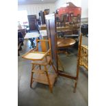 A child's high chair and a cheval mirror