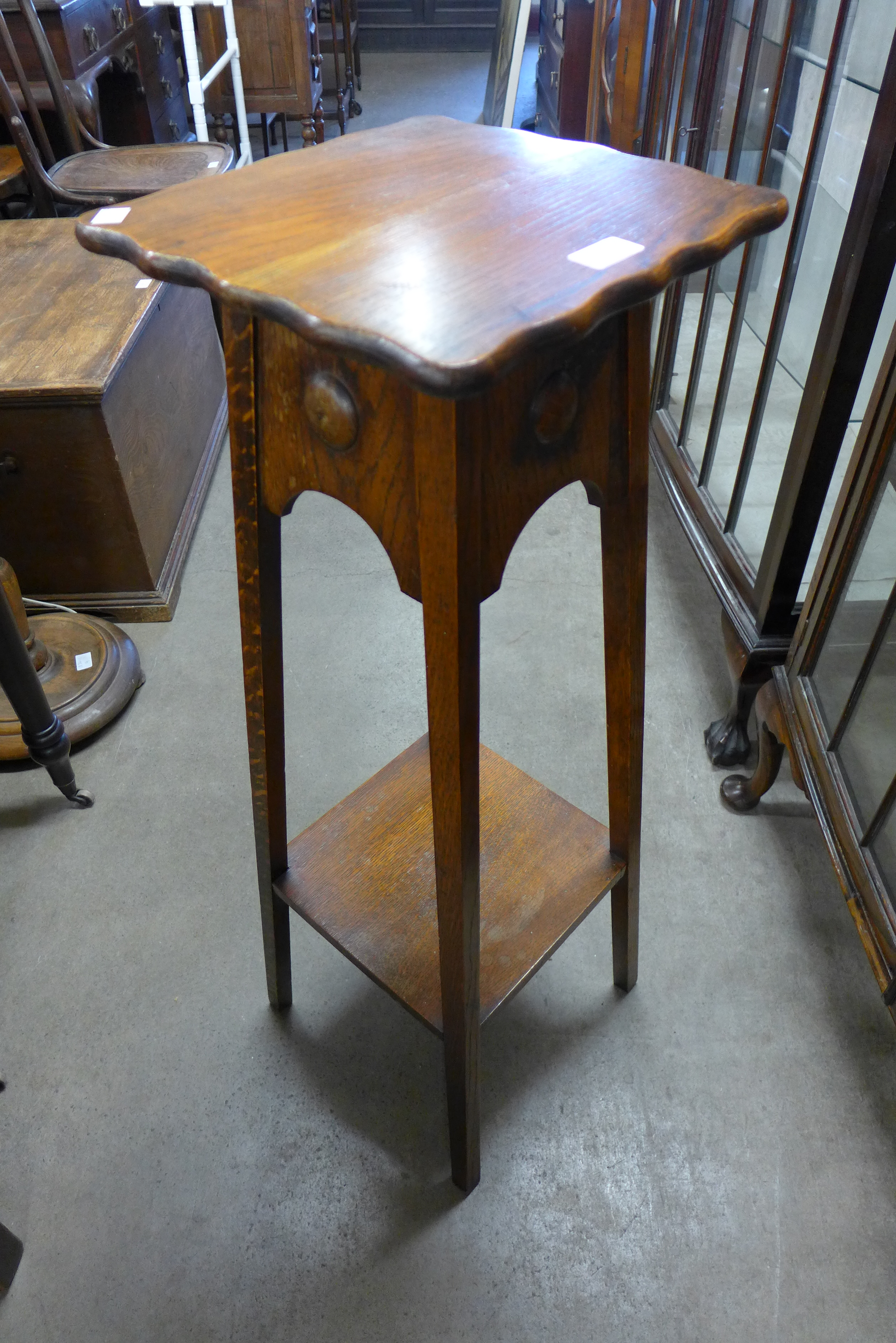 An oak jardiniere stand