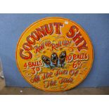 A painted circular Coconut Shy sign