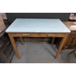 A beech and Formica topped two drawer kitchen table