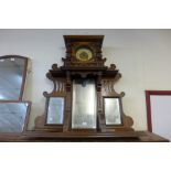 A 19th Century continental walnut overmantel mirror and clock