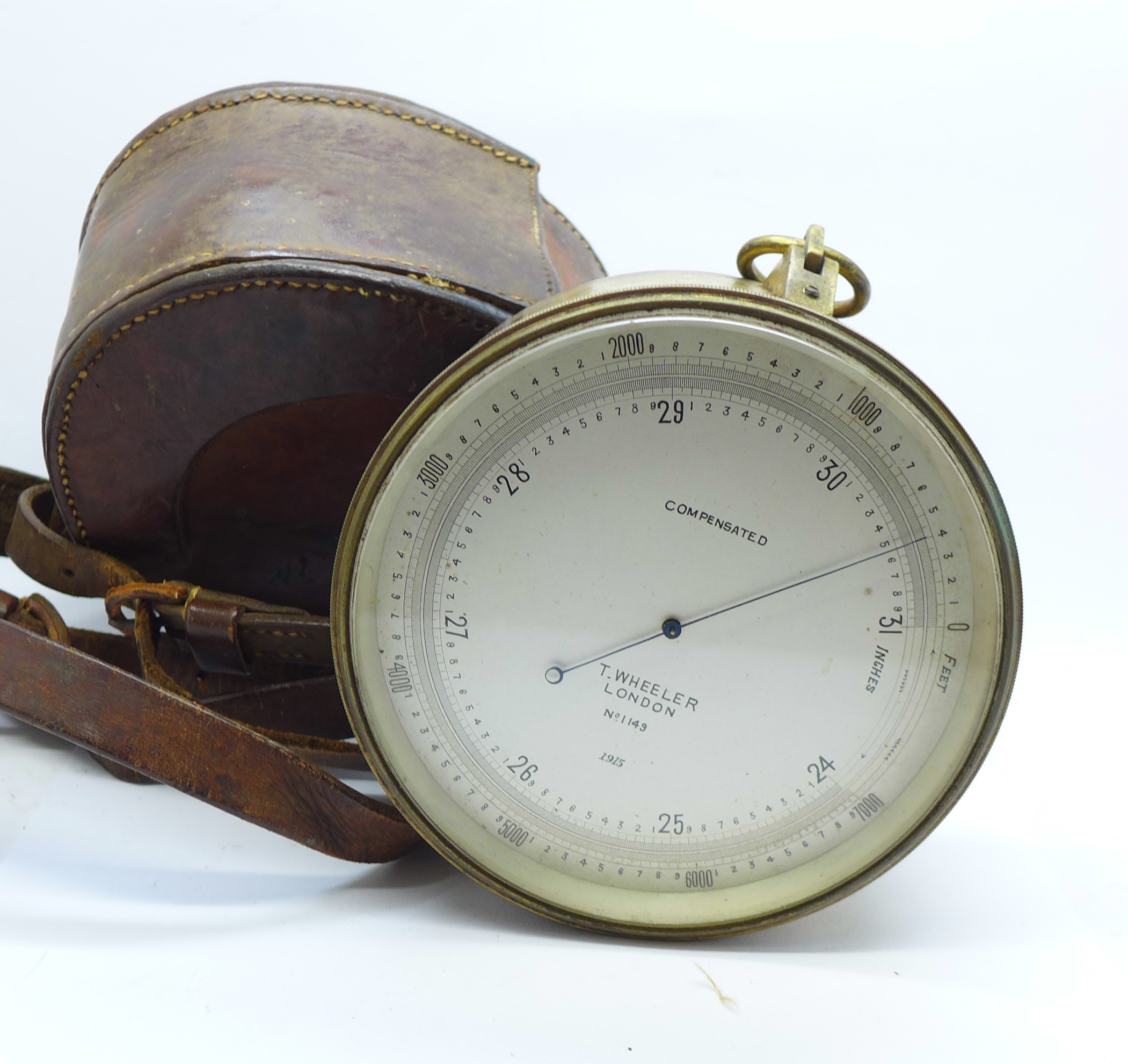 A cased barometer, marked Compensated, T. Wheeler, London, no.1149, 1915