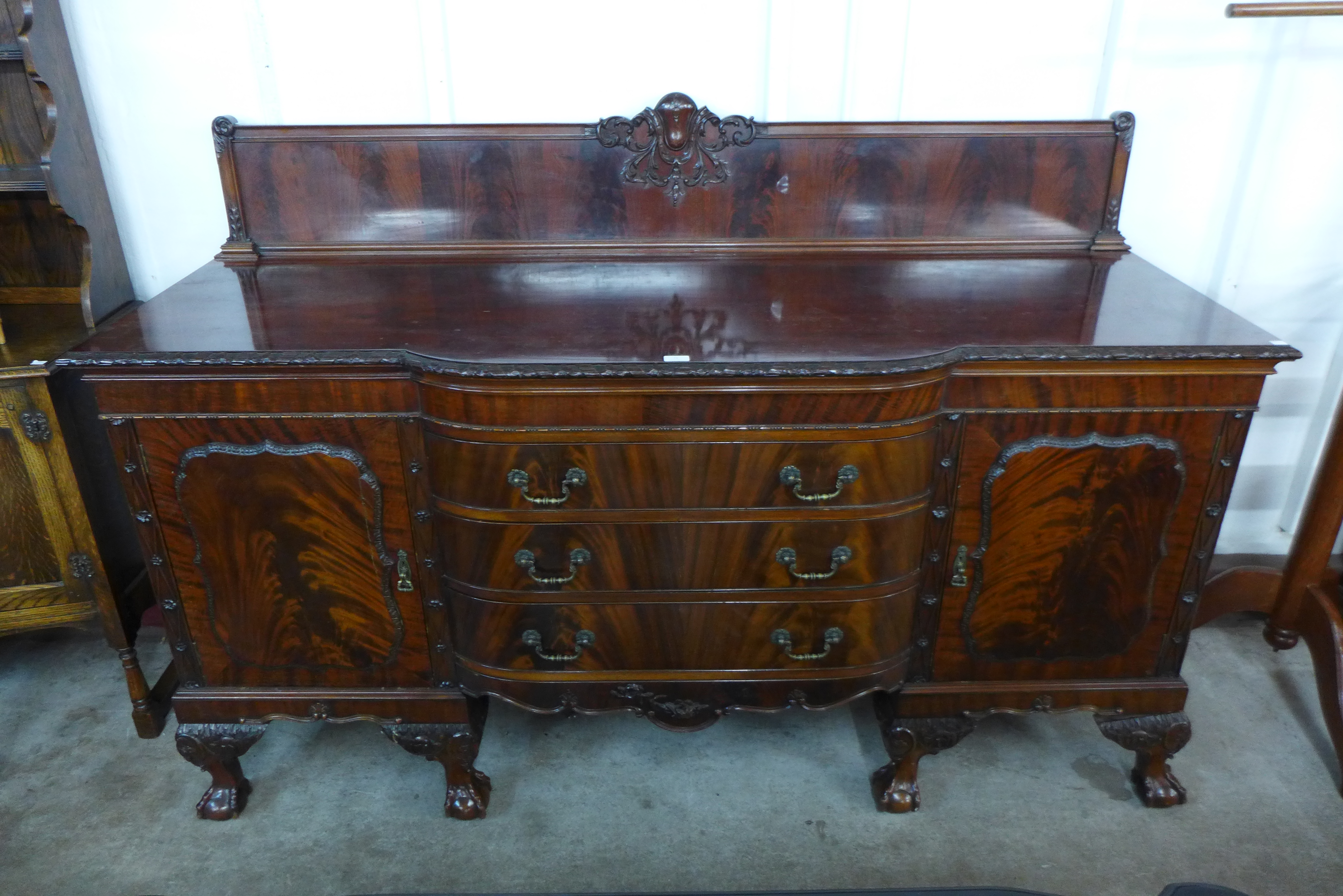 An Edward VII Chippendale Revival carved mahogany sideboard