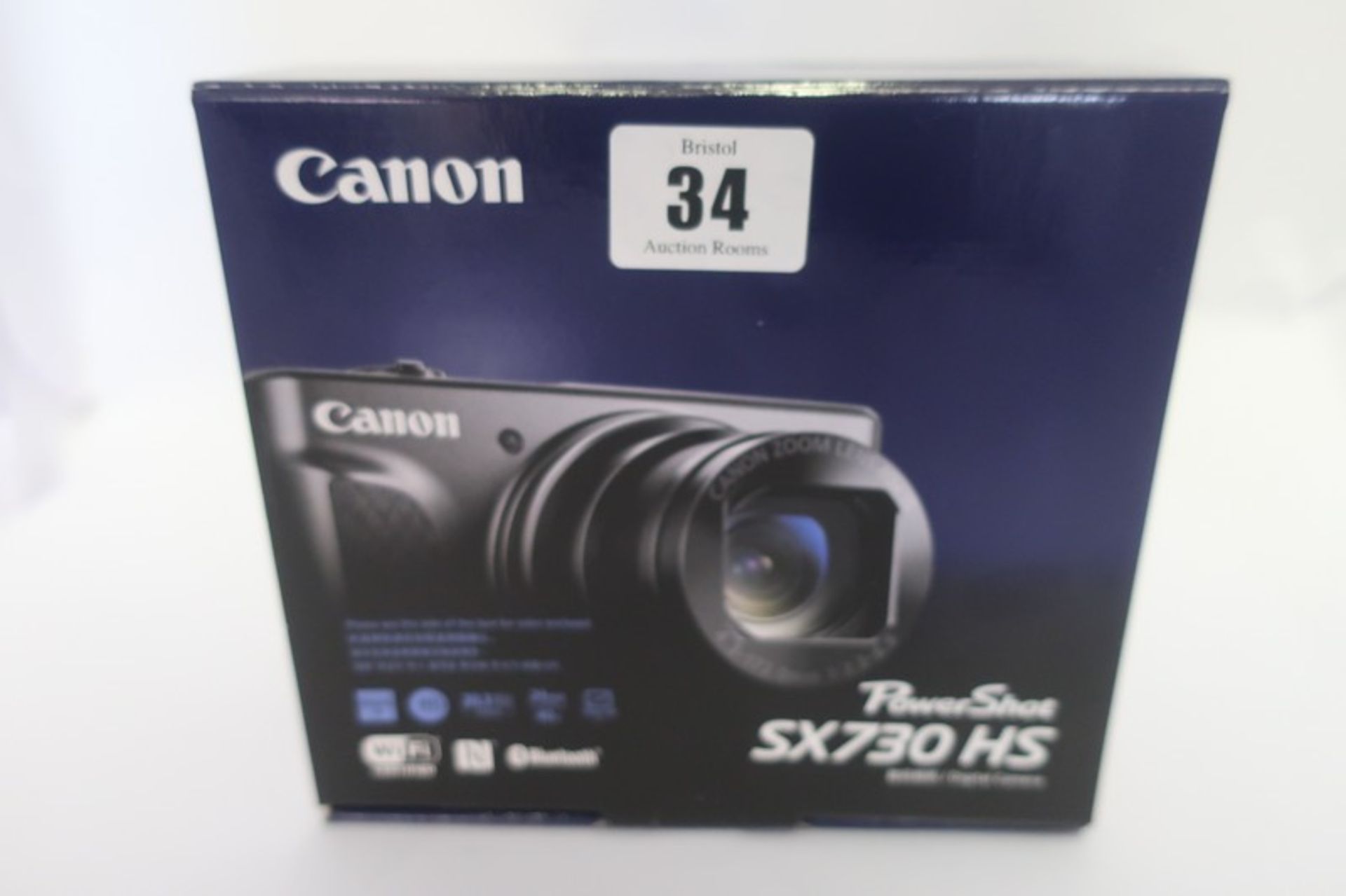 A boxed as new Canon PowerShot SX730 HS 20.3MP compact digital camera in black.