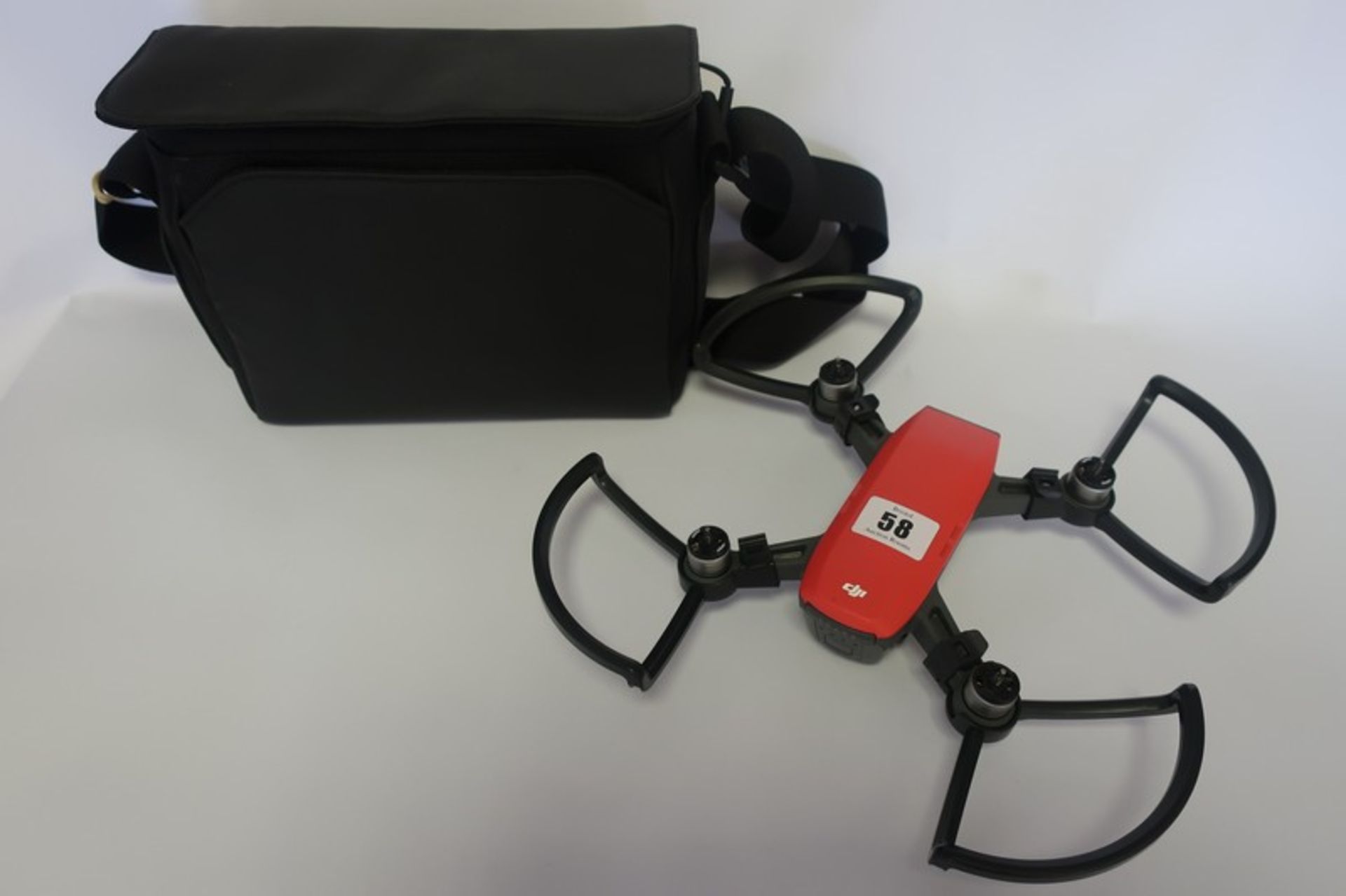 A pre-owned DJI Spark drone with three batteries and carry bag.