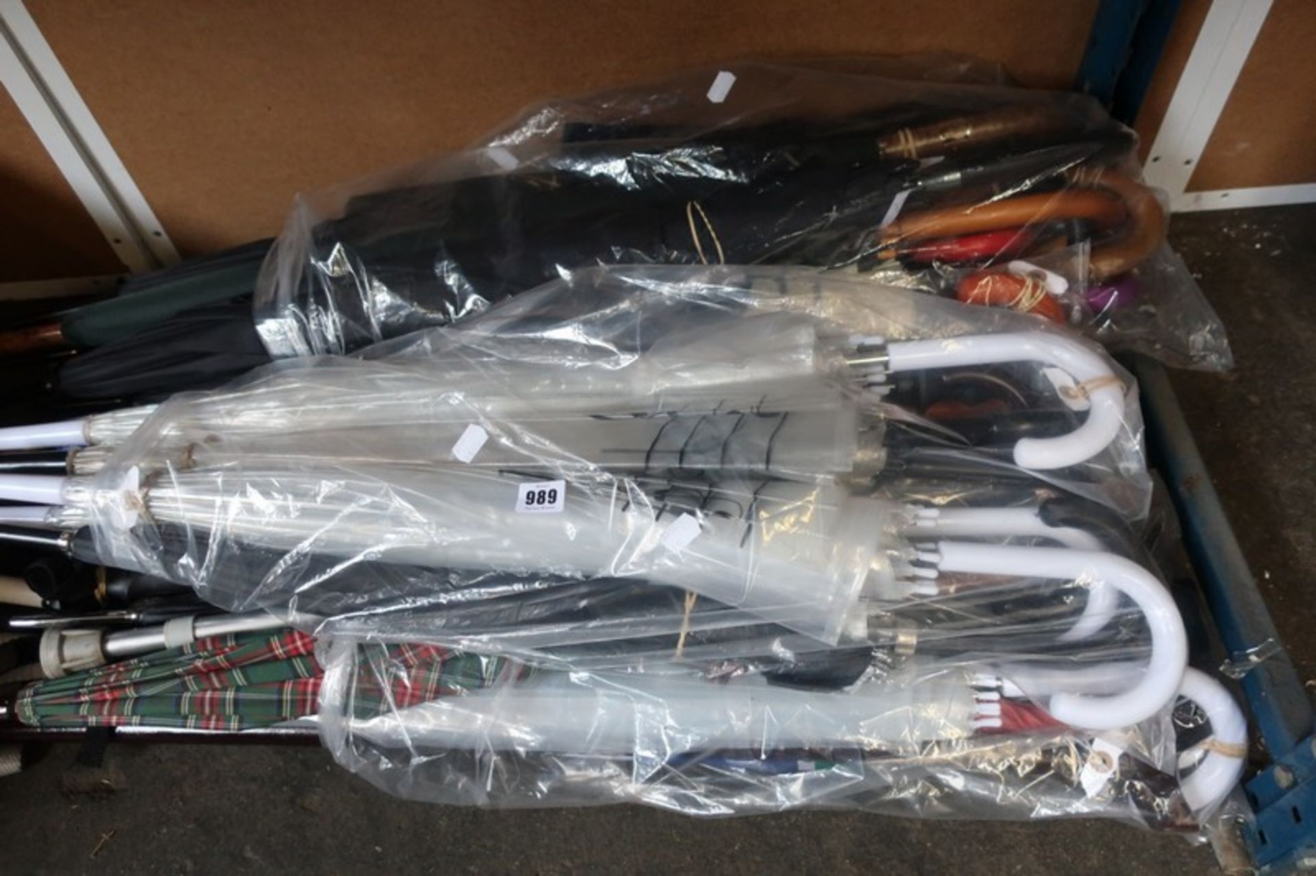 A quantity of umbrellas, walking sticks and related items.