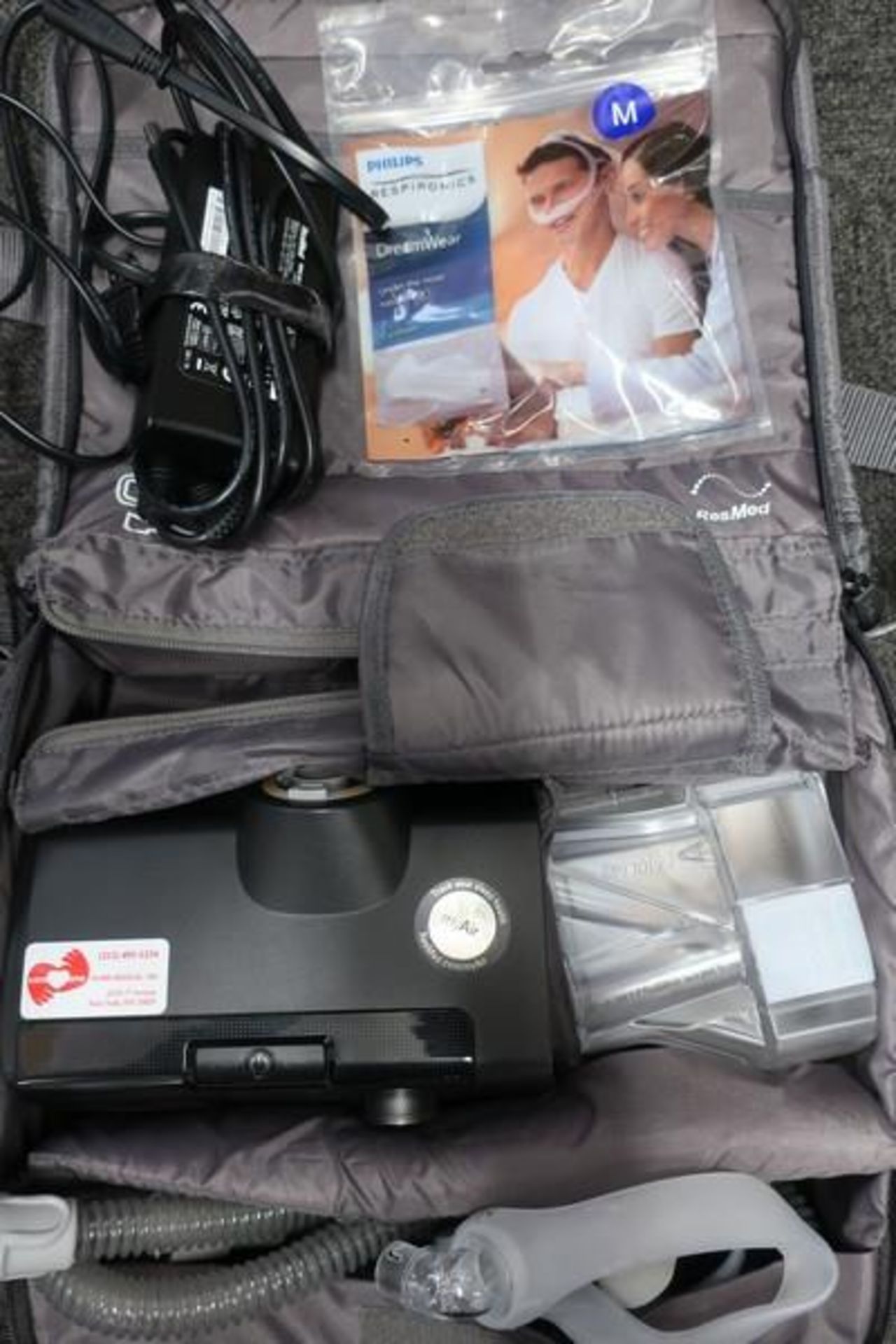 A pre-owned Resmed Airsense 10 Auto CPAP machine with power adapter in carry case.