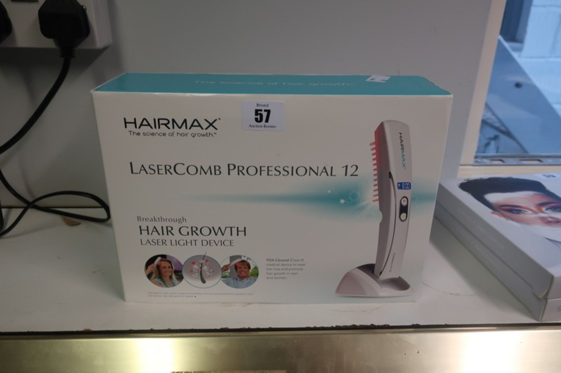 A boxed as new Hairmax Lasercomb Professional 12 hair growth laser light device.