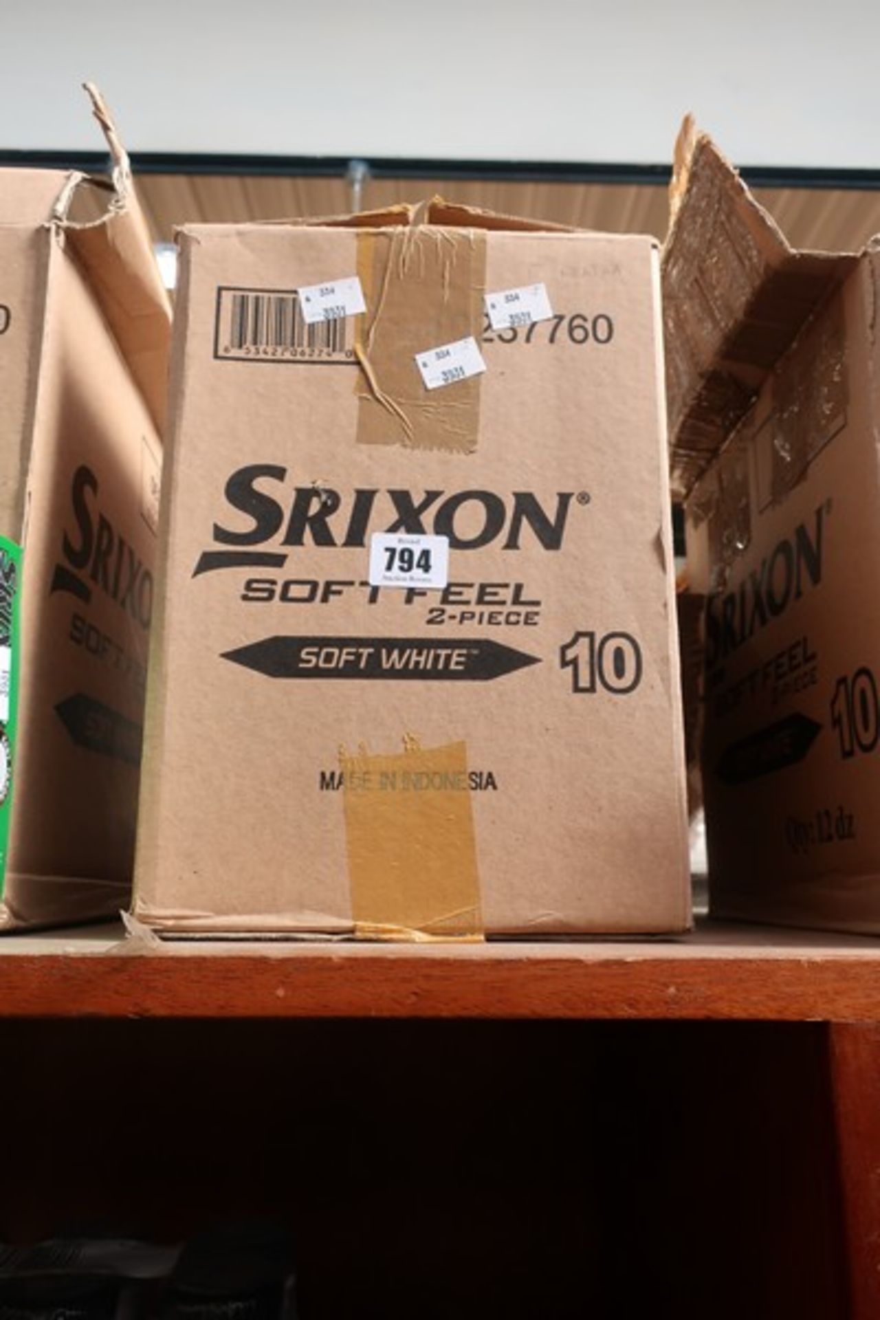 Twelve packs of Sripxon Soft Feel soft white golf balls (12 balls per pack).