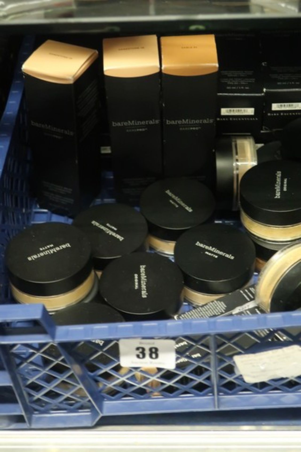 A quantity of BareMinerals performance wear liquid foundations various shades, loose powder