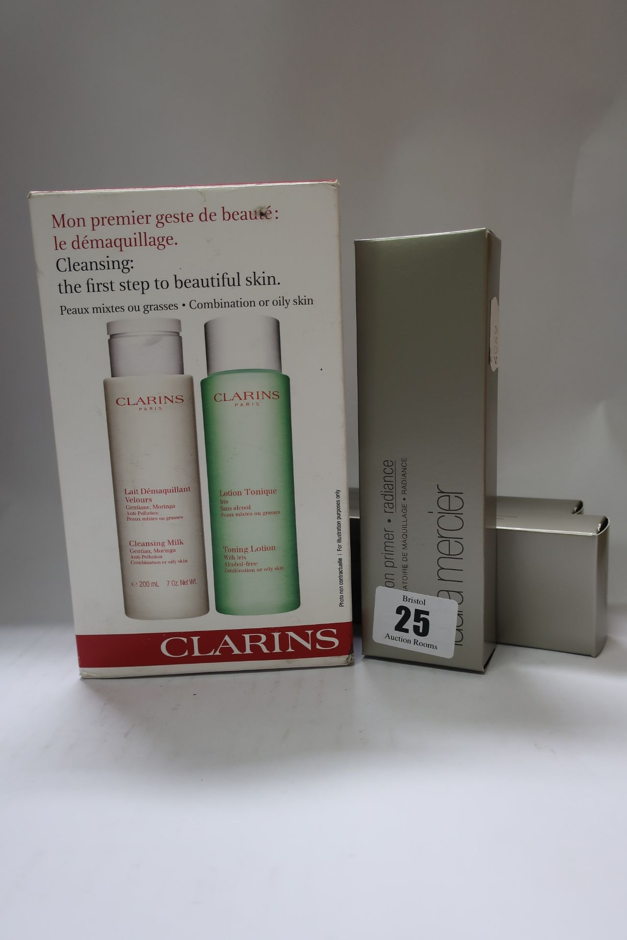 Three Laura Mercia foundation primer radiance (50ml) and a Clarins Cleanse and Tone set (200ml).