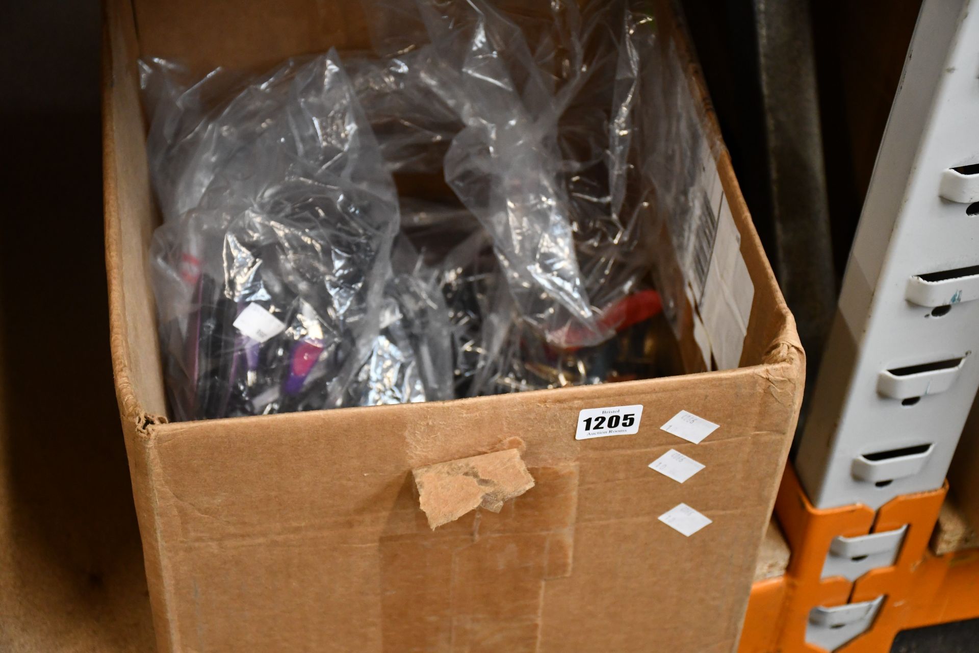 A box of assorted sharps to include scissors, nail clippers and nail files.