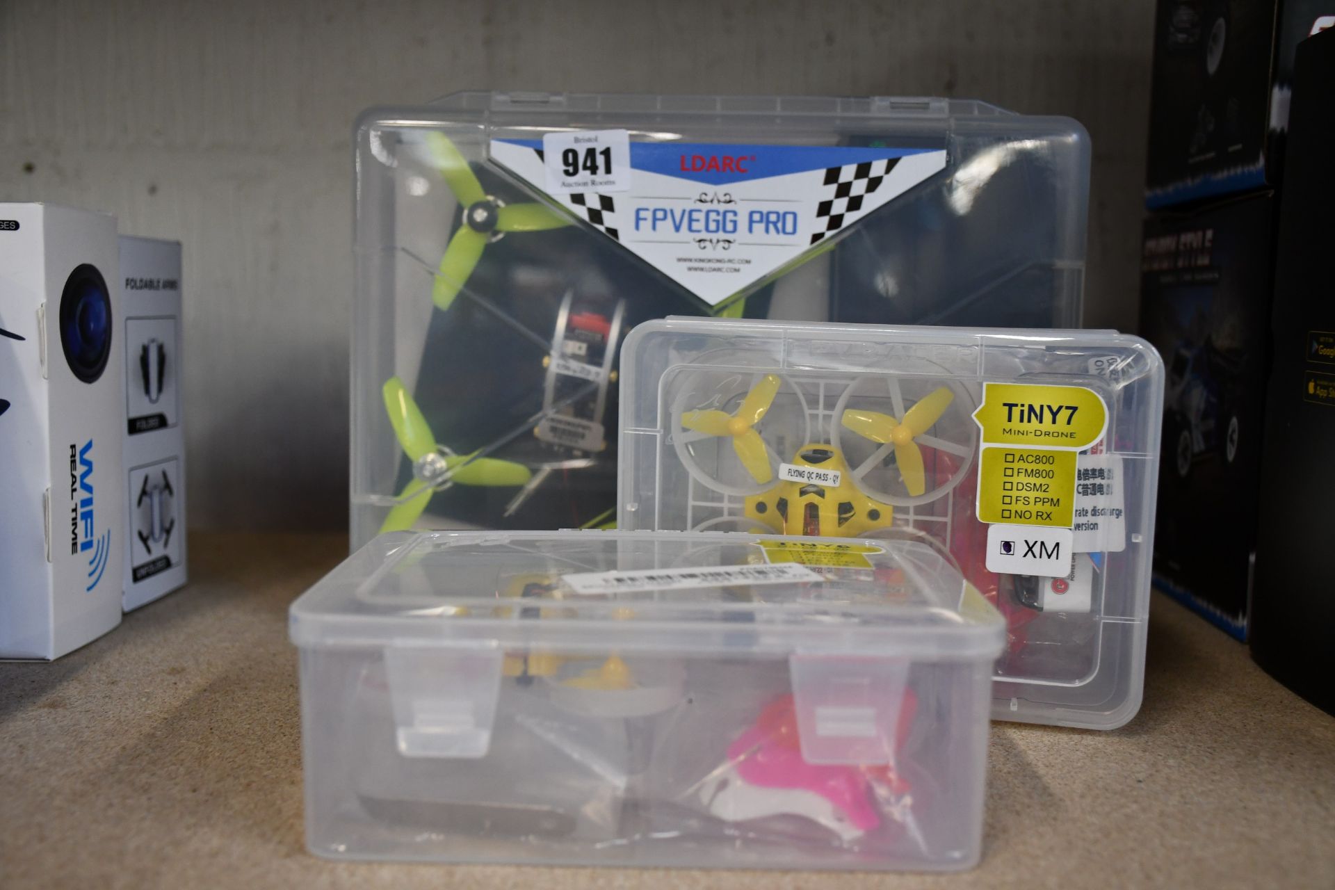 A boxed as new Ldrac FPVEGG Pro racing drone together with a TiNY6 mini drone and a TiNY7 mini
