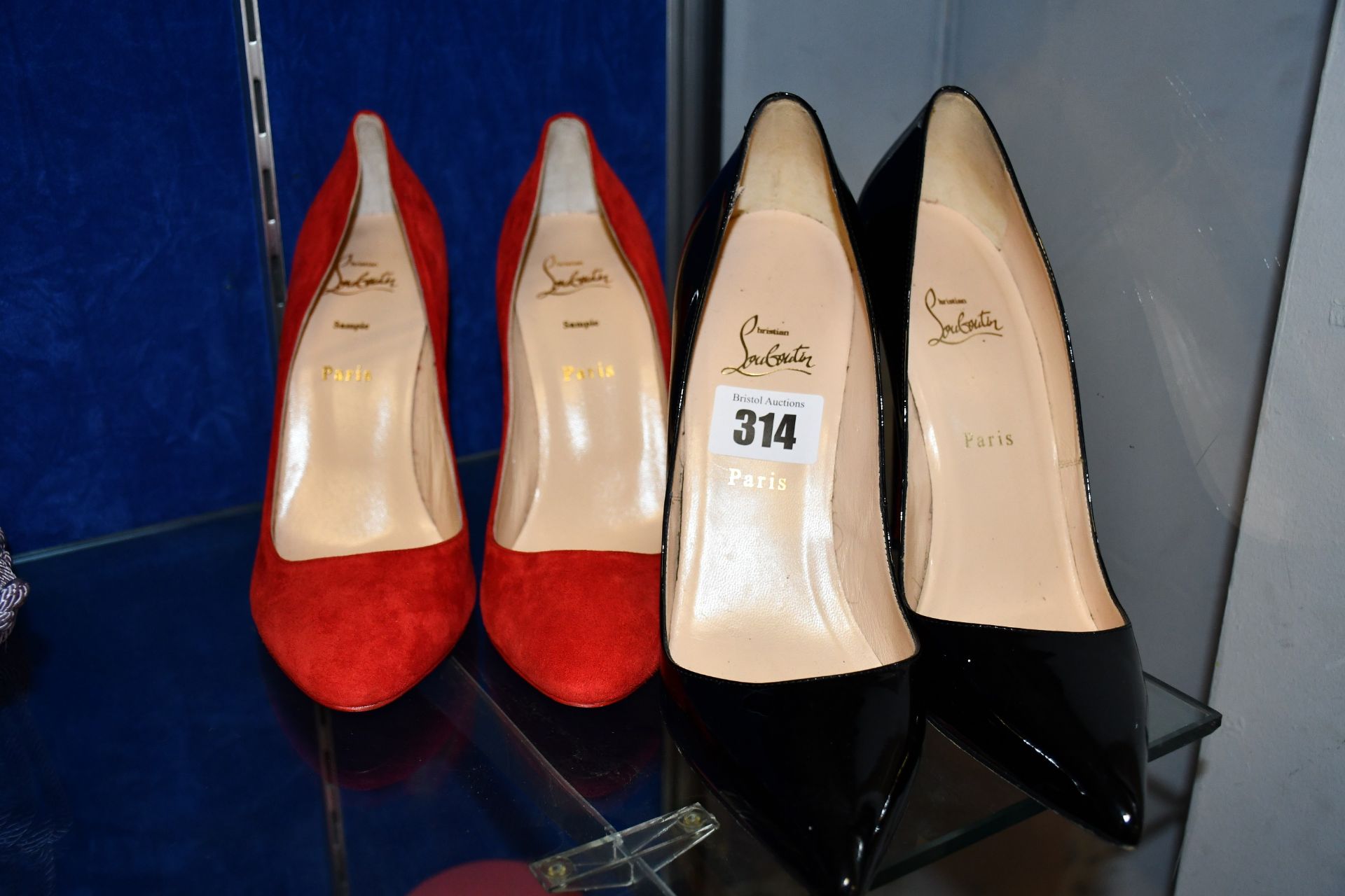 Two pairs of Christian Louboutin shoes; one sample pair in red (Size 41 - shows signs of very