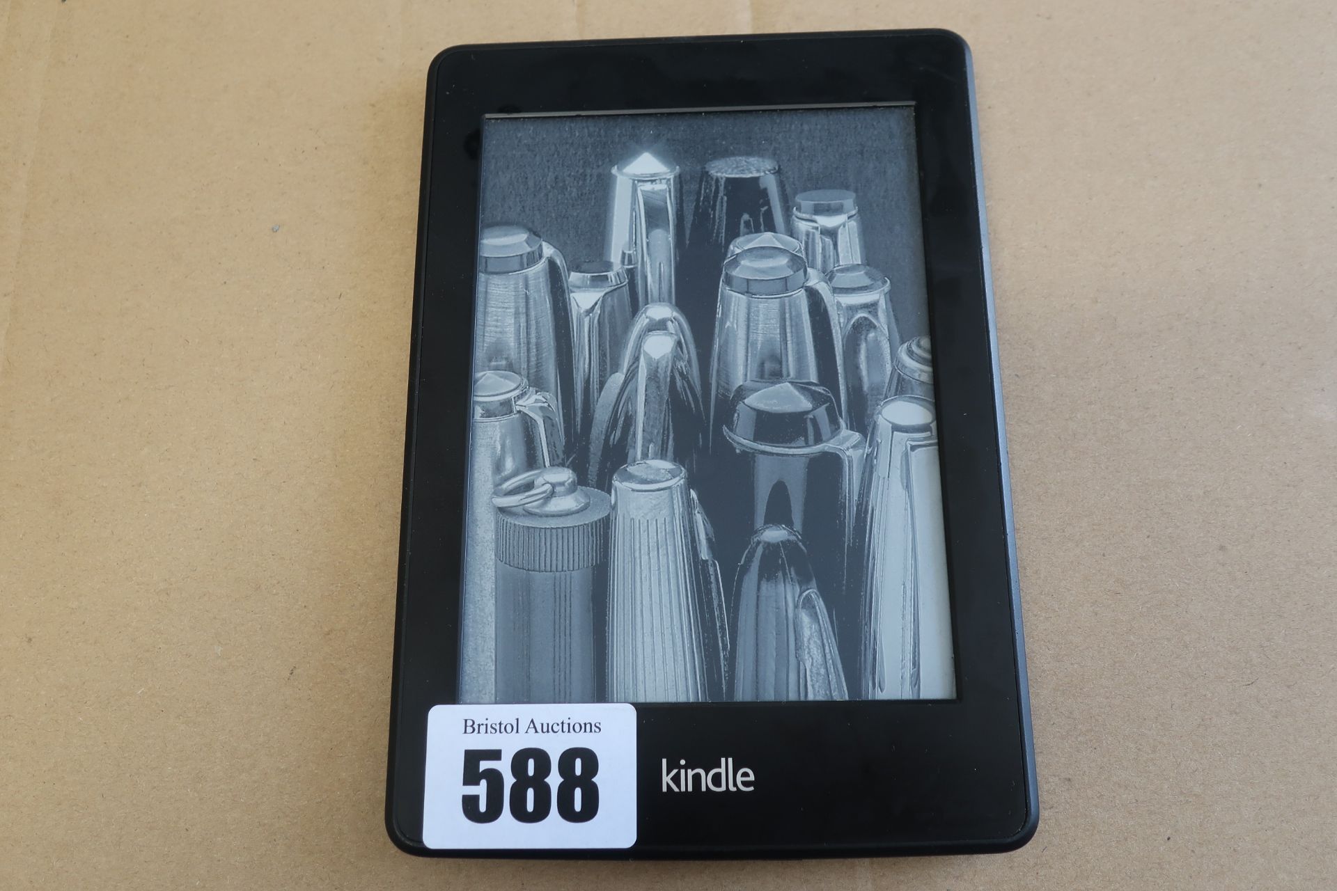 A pre-owned Amazon Kindle Paperwhite (DP75SDI) 6” E-Reader in Black.