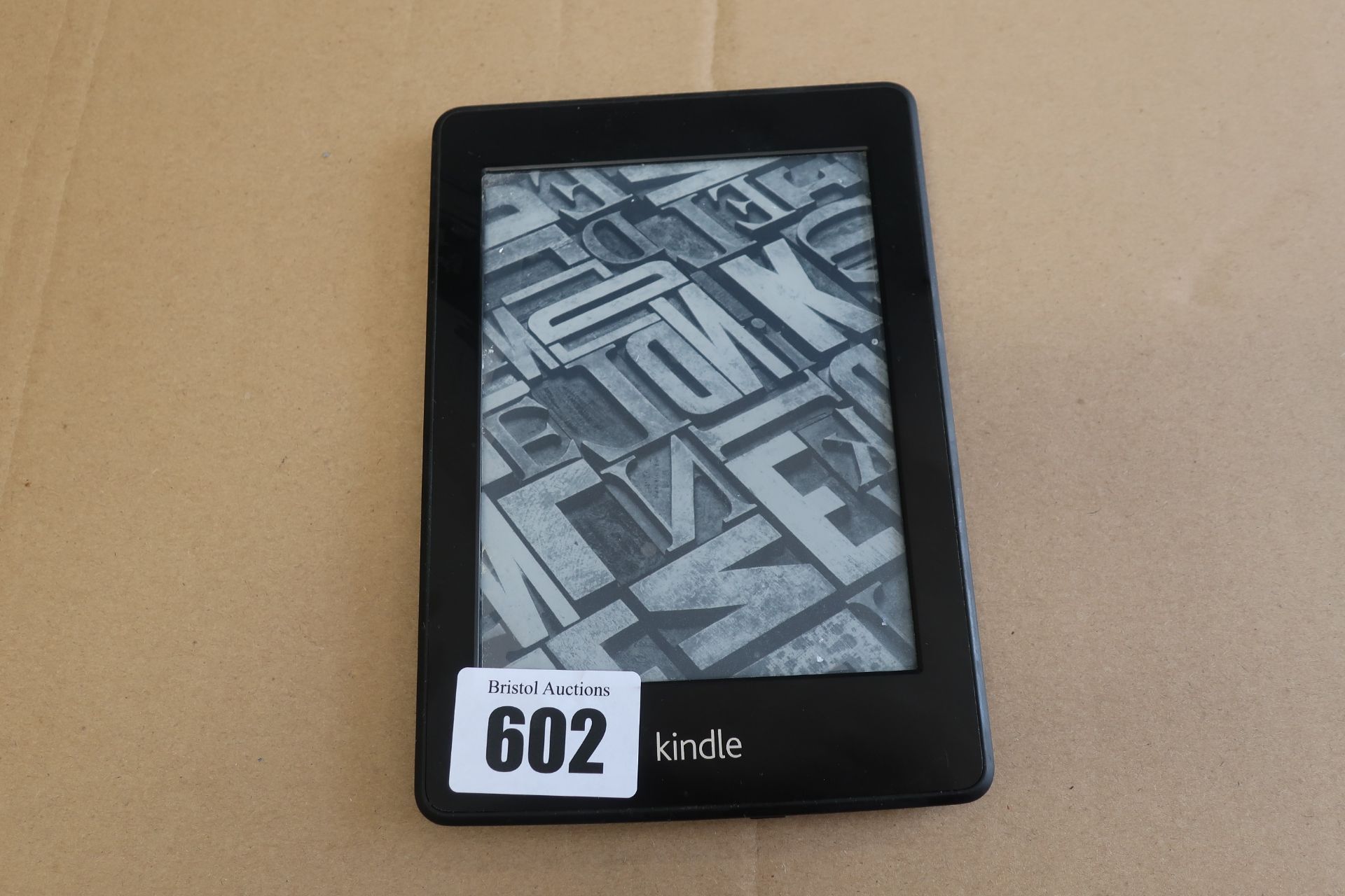 A pre-owned Amazon Kindle Paperwhite (EY21) 6” E-Reader in Black.