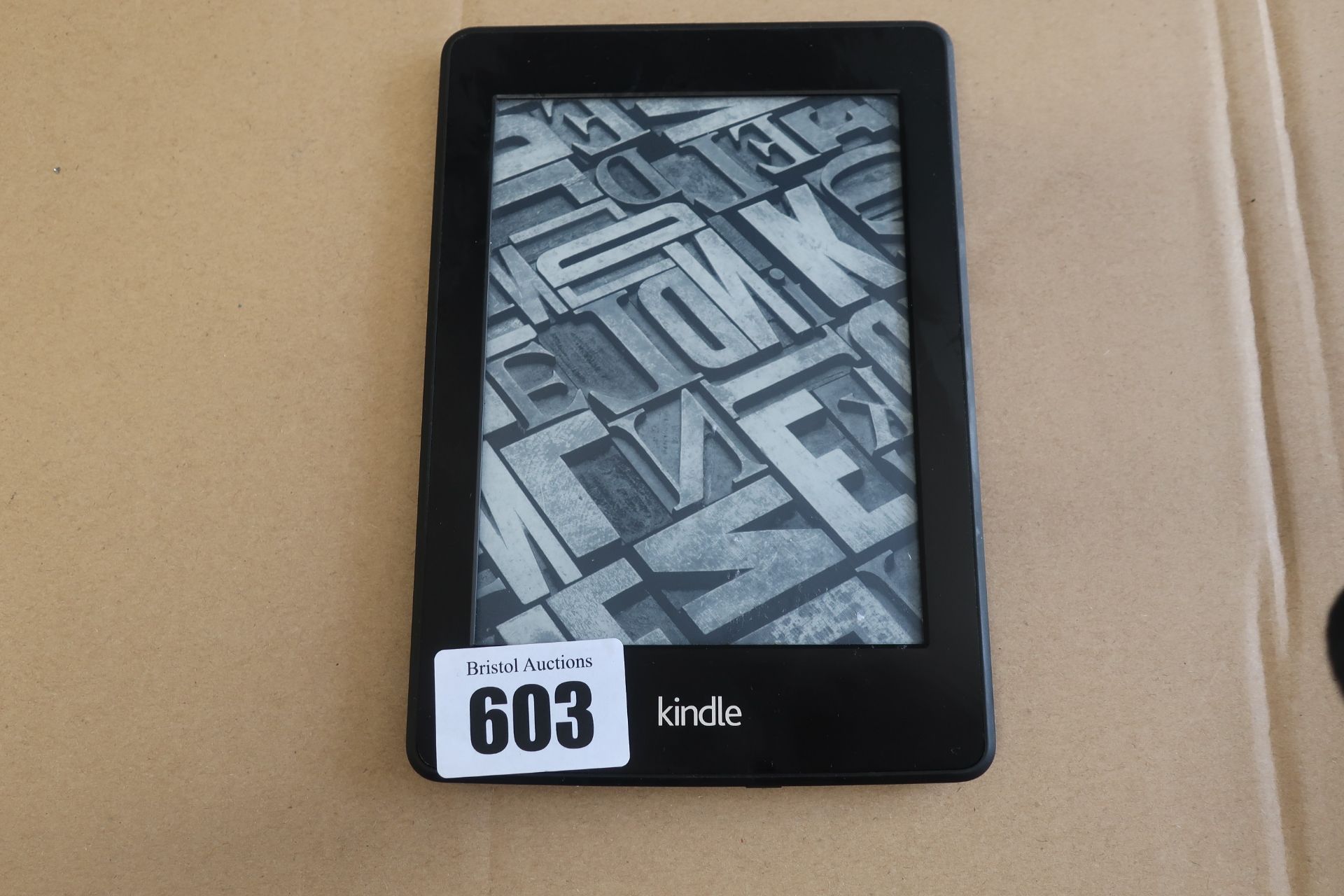 A pre-owned Amazon Kindle Paperwhite (DP75SDI) 6” E-Reader in Black.