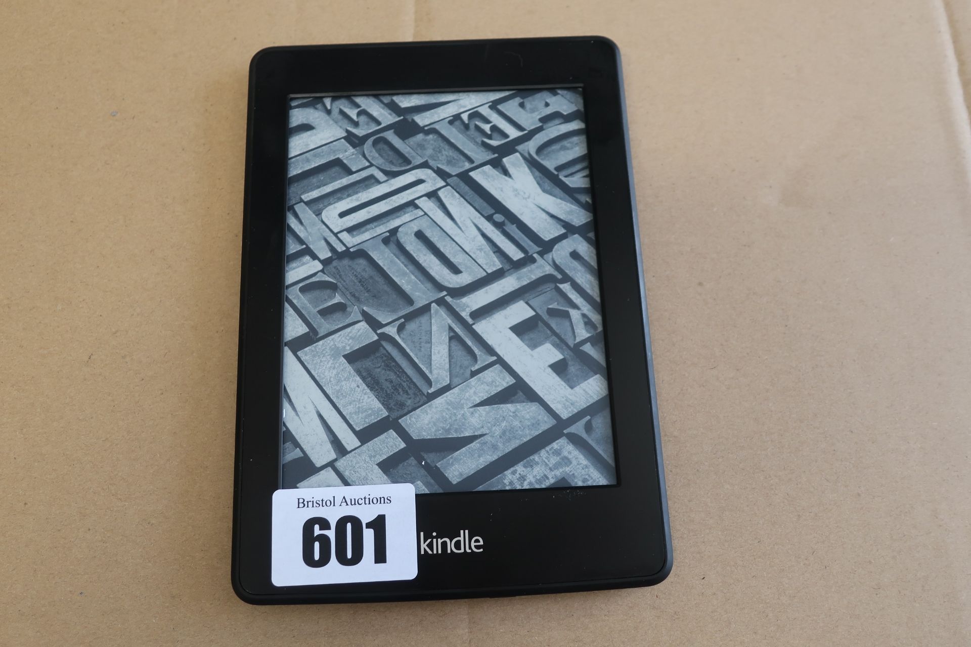 A pre-owned Amazon Kindle Paperwhite (DP75SDI) 6” E-Reader in Black.