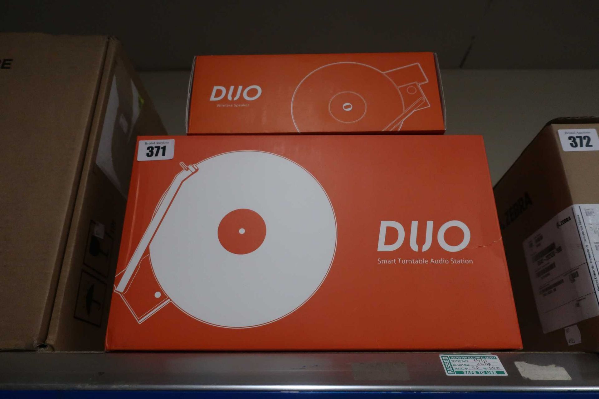 A boxed as new Hym DUO Turntable with Detachable Bluetooth Speaker in orange/grey and a boxed as new