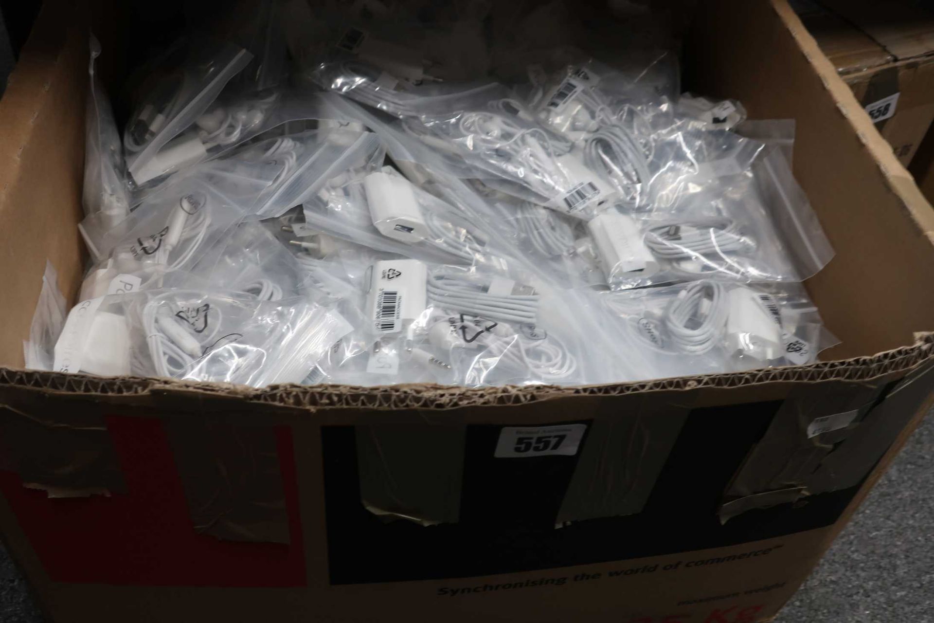 A box of unbranded phone accessories packs containing USB Lightning cable, 2-Pin EU mains charger