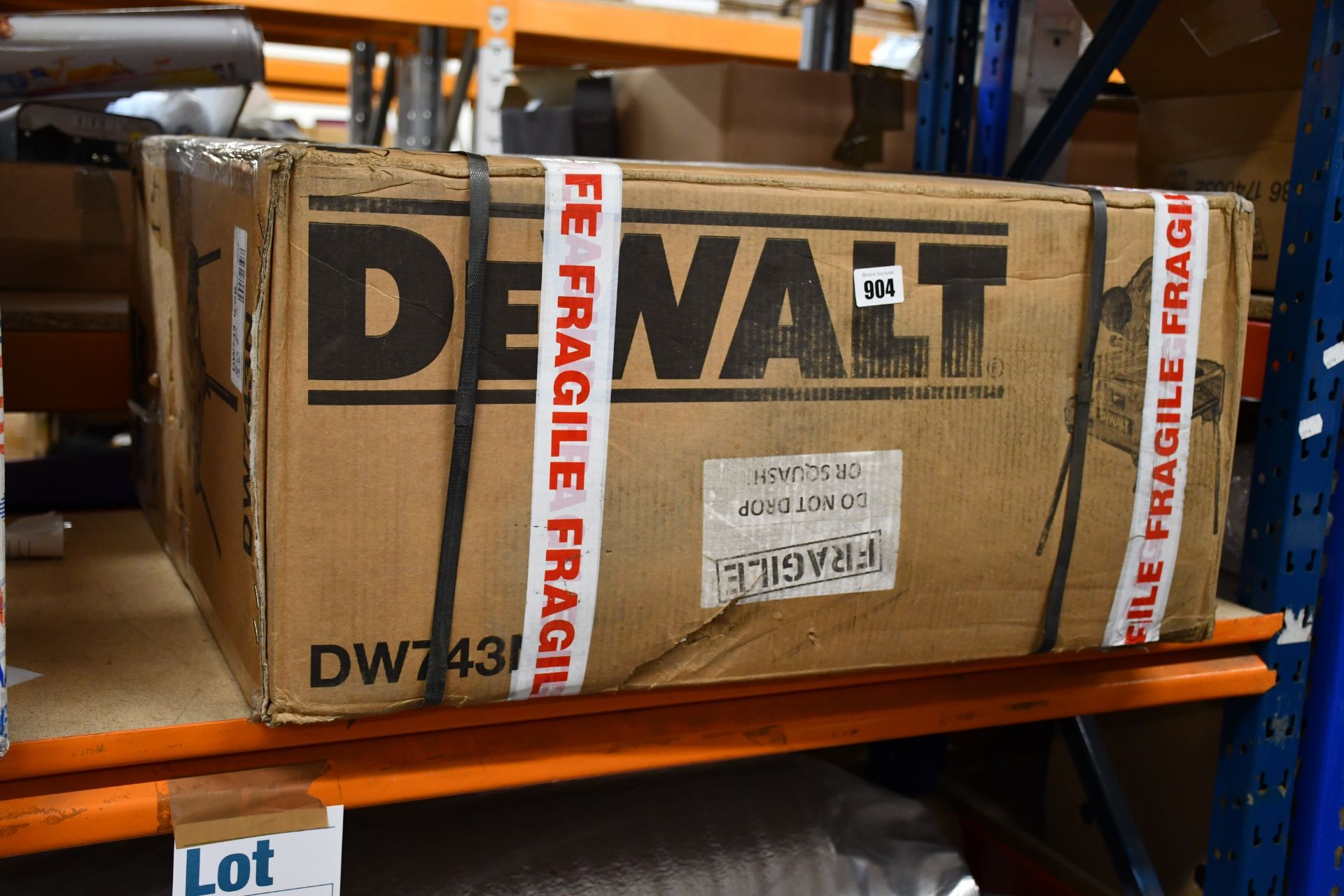 A boxed as new Dewalt flip saw (DW743N).